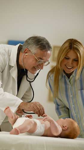 Pediatrician checking baby