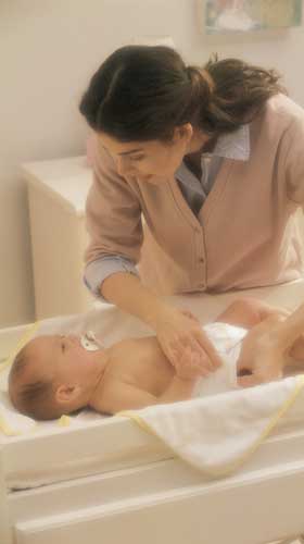 Mom changing baby's diaper