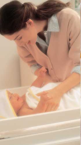 Mother drying baby in towel