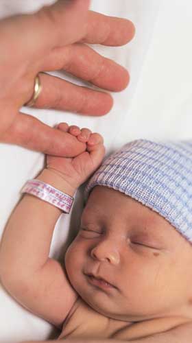 Newborn holding daddy's finger