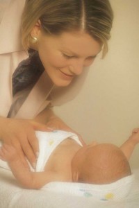 Mother cooing newborn.