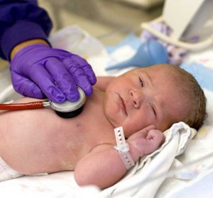 Newborn getting check up at birth